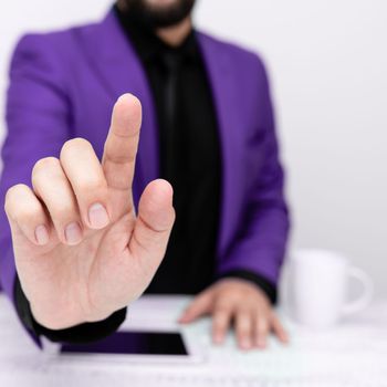 Businessman in a Purple jacket sitting at a table Phone on table.