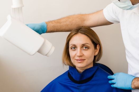 Dentist do x-ray tooth scan for woman in dentistry. Teeth x ray scanning for detect toothache and treat roots