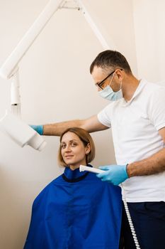 Dentist do x-ray tooth scan for woman in dentistry. Teeth x ray scanning for detect toothache and treat roots