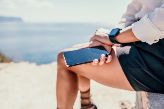 Happy girl doing yoga with laptop working at the beach. beautiful and calm business woman sitting with a laptop in a summer cafe in the lotus position meditating and relaxing. freelance girl remote work beach paradise