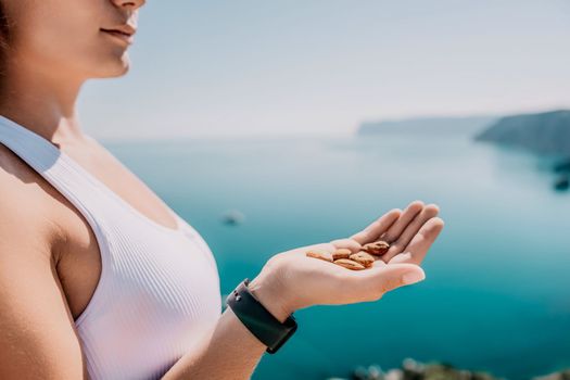 Unrecognizable caucasian woman eating young milky almond nuts. Healthy vegan food