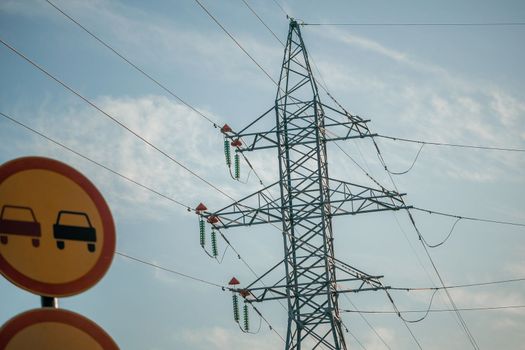 Silhouette High voltage electric tower on sunset time, distribution electric substation with power lines and transformers.