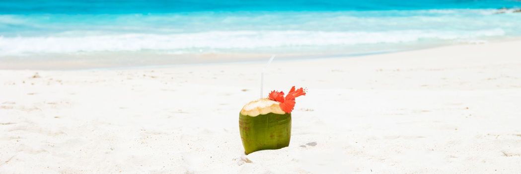 Coconut drink on a tropical beach La Digue Seychelles Islands.