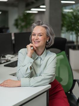 Mature caucasian woman at the desk in the office