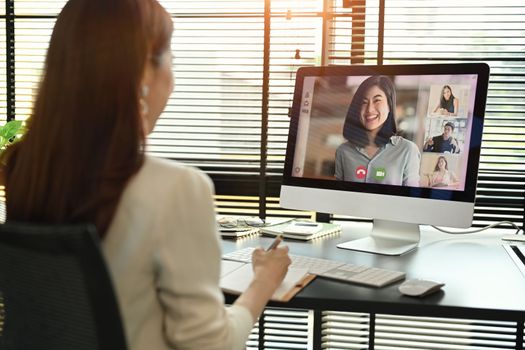 Millennial female manager communicating by video conference on computer. Distant webinar, online negotiations concept.