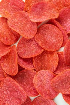 Red chips with hot pepper taste on a white background. Beer snack. Close-up