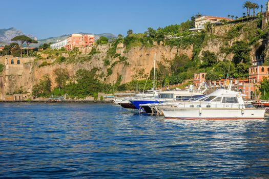 Idyllic Sorrento city cliffs and marina with boats and yacht, amalfi coast, Italy
