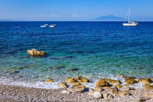 Capri island beach and coastline with boats and sailboats, amalfi coast, Italy
