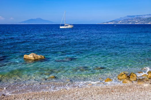 Capri island beach and coastline with boats and sailboats, amalfi coast, Italy