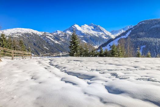 Snow ground and snowcapped ountain range in Tyrol near Innsbruck at sunny day, Austria