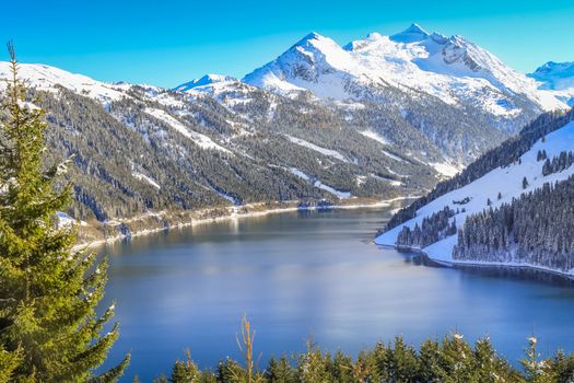Alpine lake reservoir, idyllic landscape near Zillertal alps valley, dramatic Tyrol Snowcapped mountain range panorama, Austria