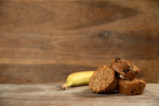 Banana muffins cake on wooden background copy space, Stack of banana cupcakes walnut, healthy low carb diet concept. vegan food kitchen