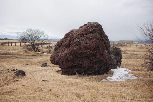 A large volcano penza stone in a deep Buryat village lies motionless waiting for travelers