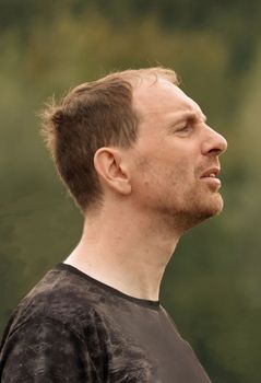 Portrait of a man listening intently to someone explaining in front of a crowd