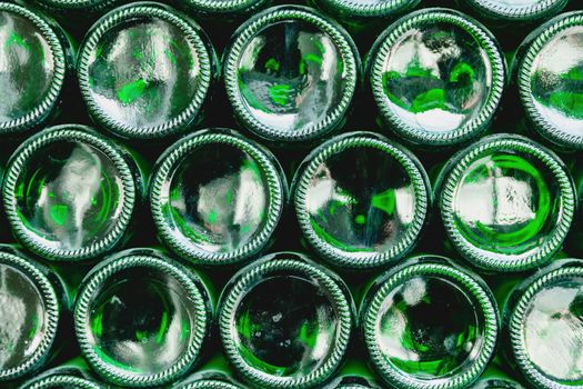 Glass bottles green. Green glass bottles of beer. Wall formed by green bottles. Green bottles background. Empty Glass Bottle with Lighting.