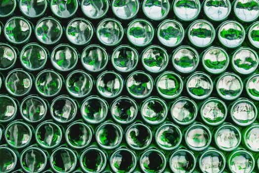 Glass bottles green. Green glass bottles of beer. Wall formed by green bottles. Green bottles background. Empty Glass Bottle with Lighting.
