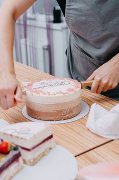 A piece of chocolate cake in the cut. Preparation of mousse cake at a culinary master class. Cooking at home, homemade food.