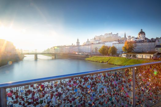 Beautiful view of Salzburg cityscape from Salzach River at misty sunrise, Austria