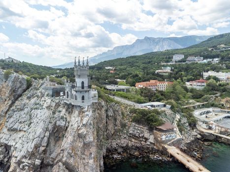 Aerial view of Swallow's Nest castle on the rock in Black Sea. It is a symbol and landmark of Crimea. Beautiful scenic panorama of the Crimea coast. Amazing Swallow's Nest at the precipice.