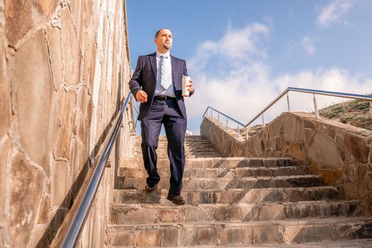 Business executive with briefcase going down the stairs.