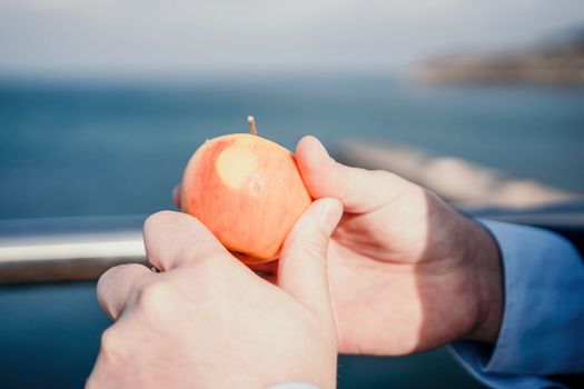 Young business people eating golden apples in lunch time discussing phone calls