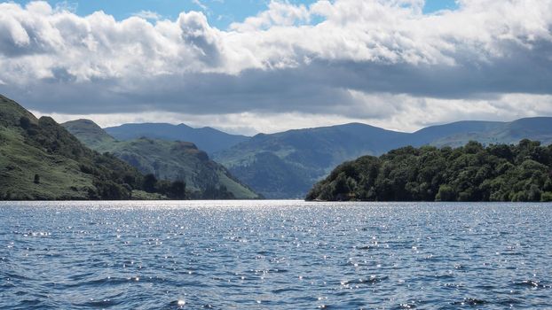 View from Ullswater looking towards the fells and mountains surrounding Glenridding, Lake District, Cumbria, UK