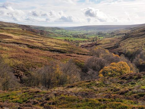 View down Rosedale from the head of the valley on the Rosedale Ironstone Railway with the ruins of the kilns of the East Rosedale Mines, North York Moors National Park, UK