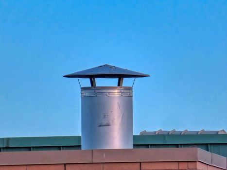 A furnace rooftop vent on a building