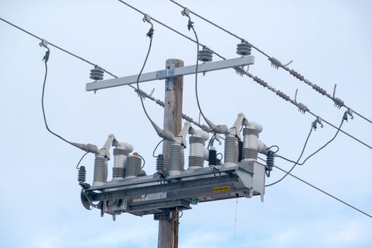 Front view of an electric three-phase overhead distribution switch. Concept: Power outages