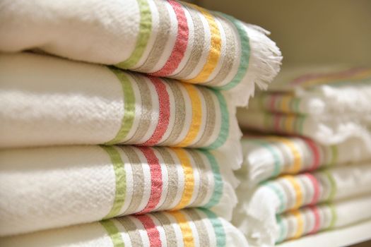 Folded bedspreads on a shelf in a shop store