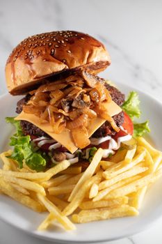 cheeseburger and fries on plate served at restaurant. High quality photo