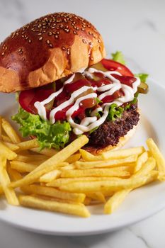 cheeseburger and fries on plate served at restaurant. High quality photo