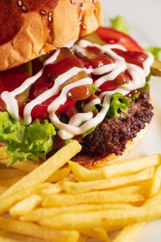 cheeseburger and fries on plate served at restaurant. High quality photo