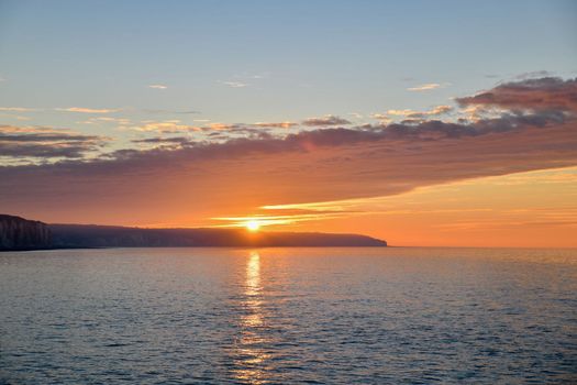 Sunset on the Atlantic ocean and reflection on a water.
