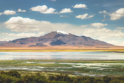 Salt lake reflection and idyllic volcanic landscape at Sunset, Atacama desert, Chile border with Bolivia