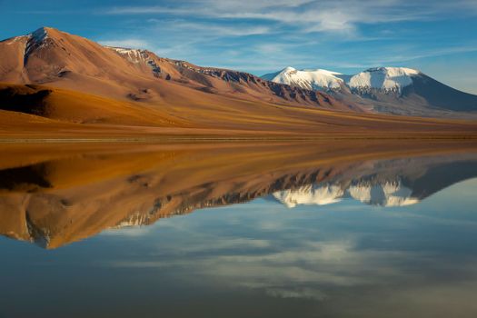 Salt lake Lejia reflection and idyllic volcanic landscape at Sunset, Atacama desert, Chile