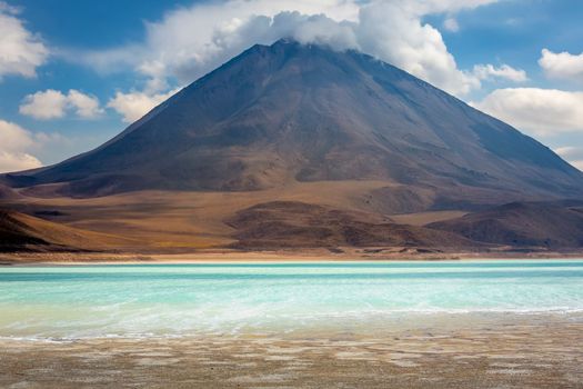 Salt lake reflection and idyllic volcanic landscape at Sunset, Atacama desert, Chile border with Bolivia