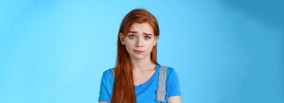 Doubtful questioned girlfriend look camera full disbelief, raise eyebrow frowning confused, hear strange weird nonsense talks, stand blue background, smirk unsatisfied, feel uncomfortable.