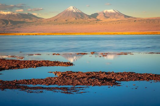 Licancabur and Peaceful reflection lake with dramatic volcanic landscape at Sunset, Atacama Desert, Chile