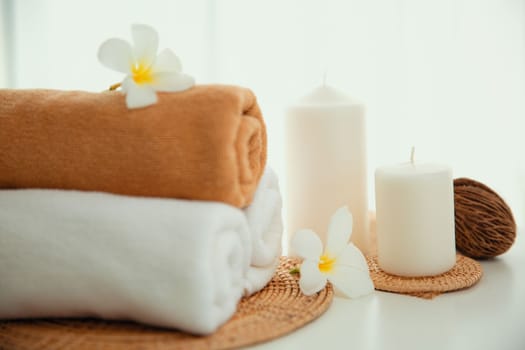 Spa accessory composition set in day spa hotel , beauty wellness center . Spa product are placed in luxury spa resort room , ready for massage therapy from professional service .