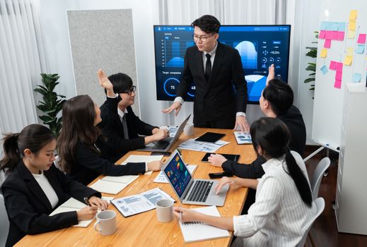 Confidence and asian businessman give presentation on financial analyzed by business intelligence in dashboard report to other people in board room meeting to promote harmony in workplace.