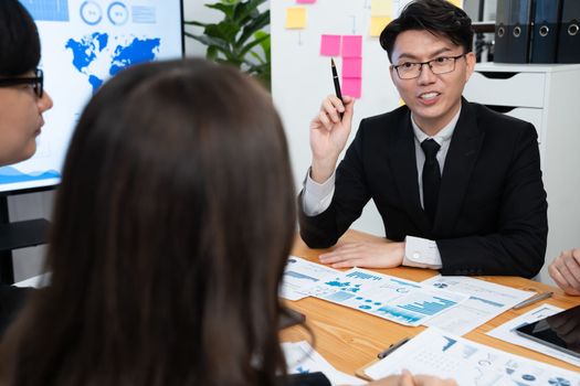 Business team of financial data analysis meeting with business intelligence, report paper and dashboard on laptop for marketing strategy. Business people working together to promote harmony in office.