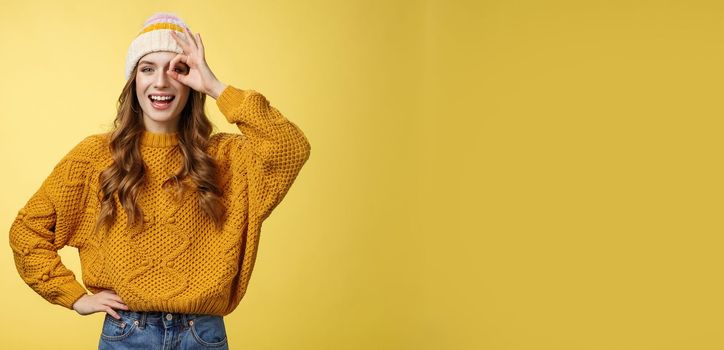 Smiling optimistic happy charming girl show okay ok gesture assuring everthing alright keep up supporting you, like awesome idea excited try out, standing satisfied yellow background.