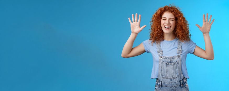 Fine you won. Cheerful carefree playful attractive redhead curly girlfriend having fun laughing out loud joyful raise hands up surrender fool around enjoy cool awesome time spending friend. Copy space