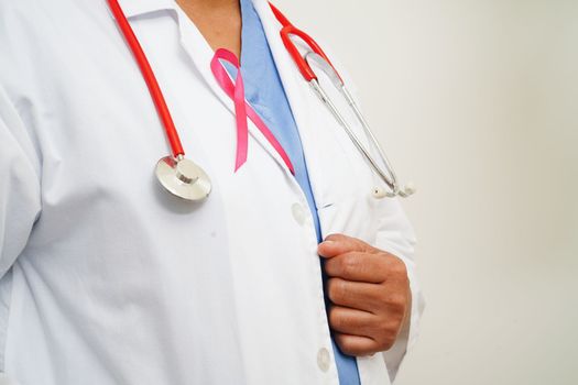 Asian woman doctor with pink ribbon, World Breast Cancer Day at October.