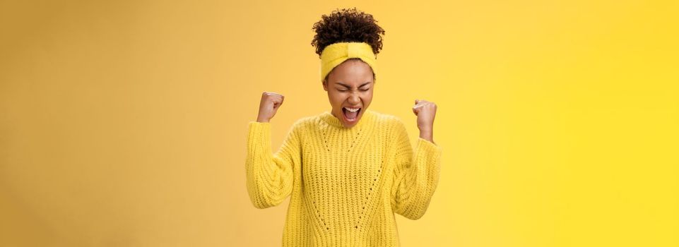 Excited thrilled beautiful young girl student yelling happily clench fists victory triumph pose dancing celebrating acception popular university standing satisfied achieve goal dream come true.