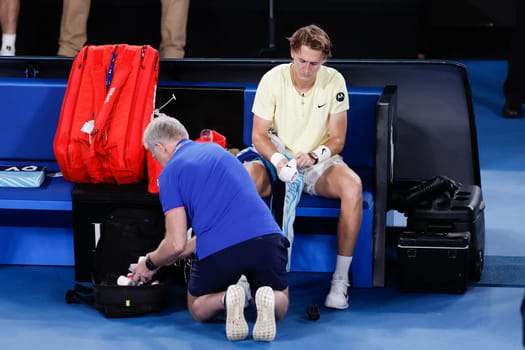 MELBOURNE, AUSTRALIA - JANUARY 24: Sebastian Korda of USA receives treatement for his wrist whilst playing Karen Khachanov of Russia in quarter final action on day 9 of the 2023 Australian Open at Melbourne Park on January 24, 2023 in Melbourne, Australia.