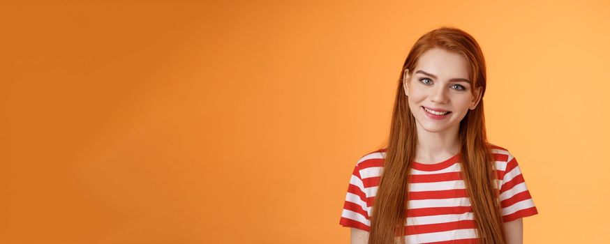 Close-up tender cute redhead young woman smiling joyfully, express happiness friendly emotions, look camera silly lovely grin, gaze satisfied, chat delighted, pleasant conversation orange background.