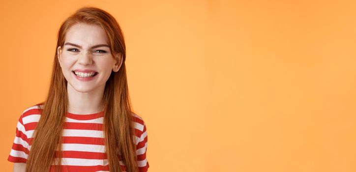 Close-up sassy good-looking cheerful redhead sly girl smiling toothy white perfect grin, satisfied dental clinic professional cleaning, standing orange background happy, joyful summer mood.