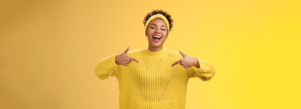 Confident good-looking outgoing black cute girl 20s in sweater headband afro hairstyle pointing heself raise head arrogant laughing bragging telling own personal goals achievements, suggest herself.